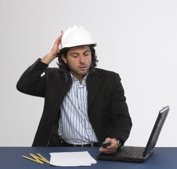 Young architect at work with mobilephone