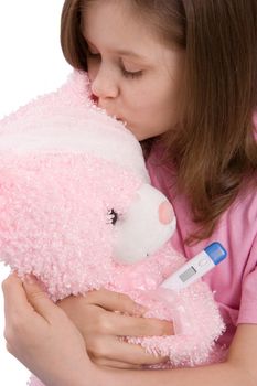 The girl embraces and kisses a toy-bear