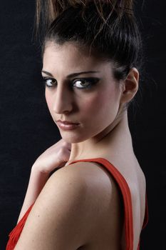 attractive young girl in red dress  looking at camera