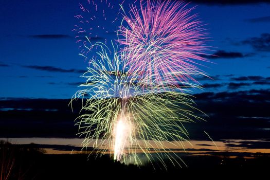 Bright and coloufull fireworks with cloudy night time sky