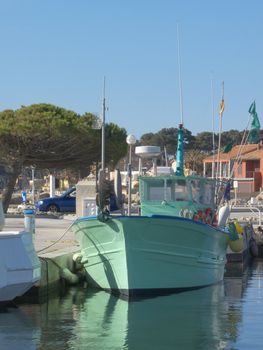 digital image of a green fisher boat in a Mediterranean harbour