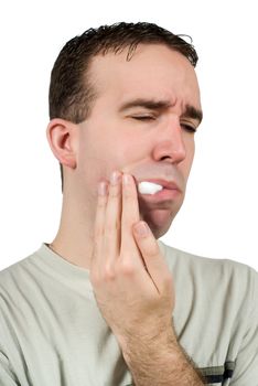 A man suffering from a toothache and holding some cotton in his mouth to help, isolated against a white background