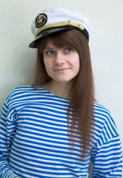 The beautiful girl in a stripped vest and cap