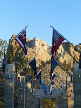 Mount Rushmore National Memorial as seen from entrance with state flags.