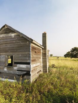 Abandoned rural wooden house in state of disrepair.