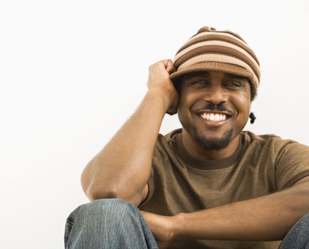 African-American mid-adult man wearing knit hat smiling at viewer.