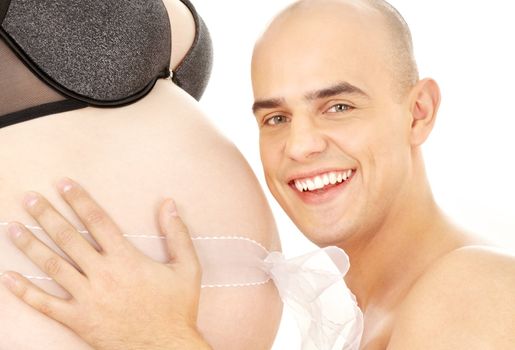 picture of happy man holding belly of pregnant woman