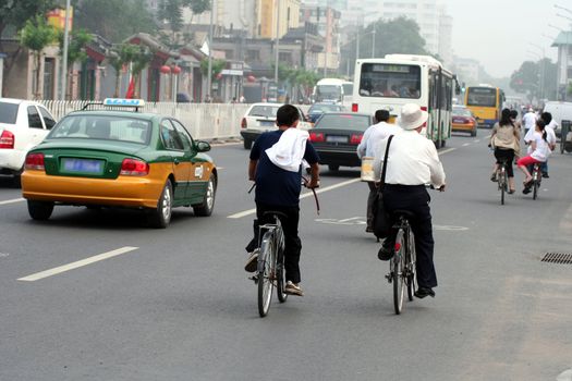 Chinese morning street scene : people going working. Picture take in Beijing.