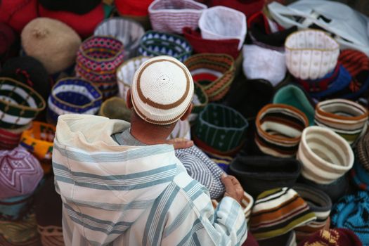 Moroccan man selling clothes in a market