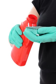 The woman in green gloves holds a bottle with a washing-up liquid