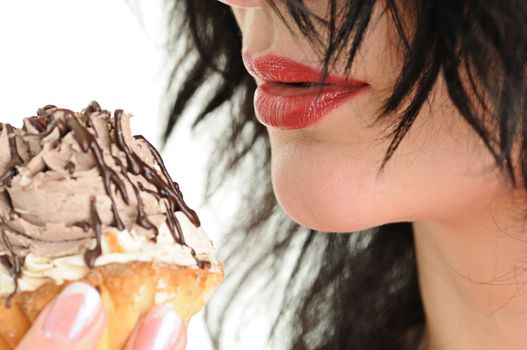 The beautiful woman eats a cake is shoot close up
