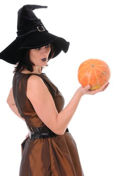 Young witch with a pumpkin isolated on white background