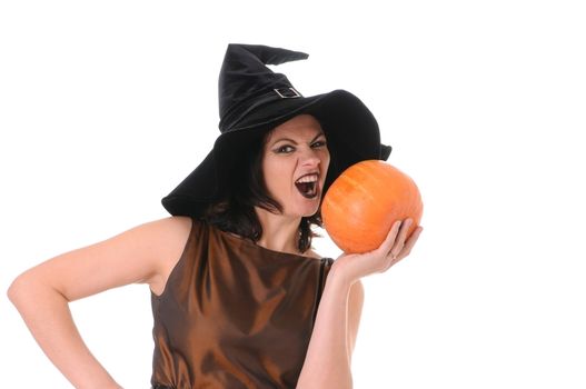 Young witch with a pumpkin isolated on white background