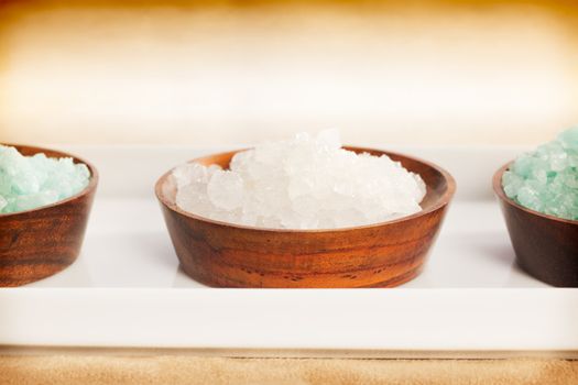Three spa salt bowls over a white plate (close up)
