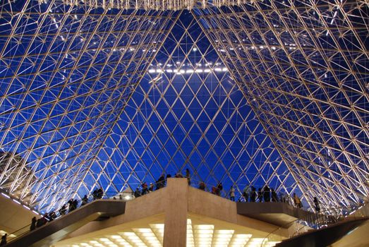 PARIS - JAN 10: Inside the Louvre pyramid on Jan 10, 2008 in Paris. Visitors leaving museum as it closes.