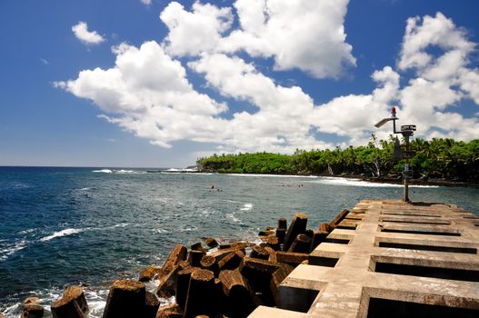 Hawaiian coast beach with man-made break water 