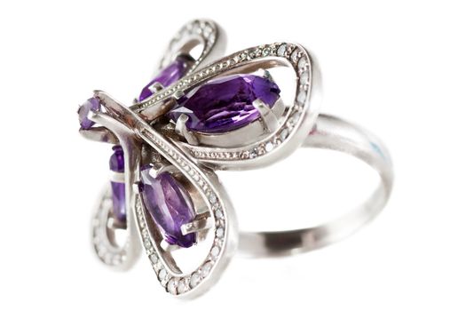 Macro view of old silver ring with violet gems.