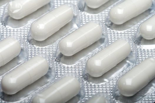 Packing with white capsules. A close up