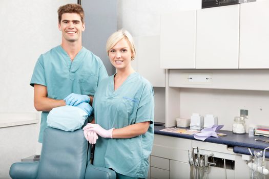 Portrait of a confident male and female dentists smiling at dental clinic