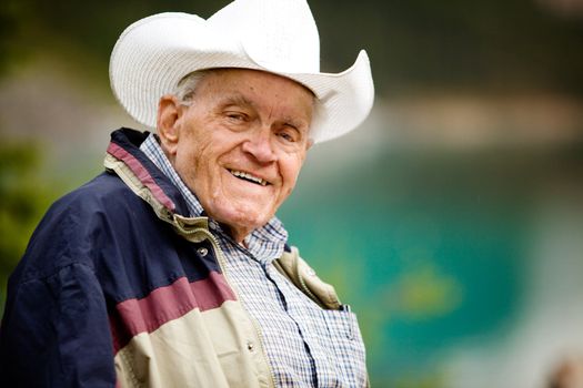 A portrait of a happy elderly man with cowboy hat