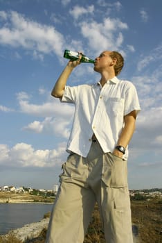 Man drinking beer in hot weather