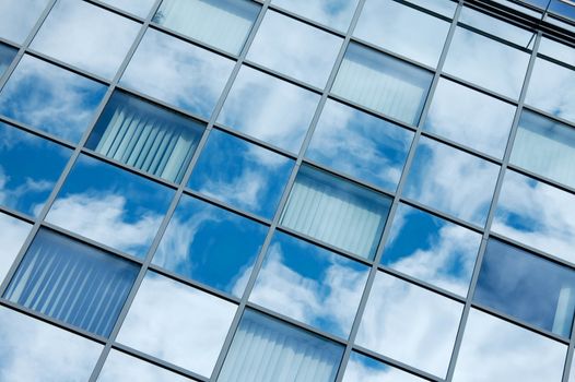 Detail of a modern office building with sky reflection
