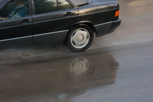 Car moving fast on slippery wet road (motion blur)