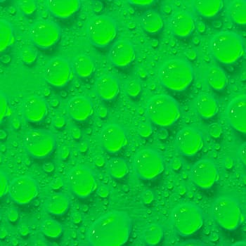 Many water droplets on green surface