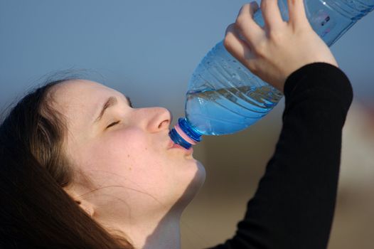 Portrait of a girl drinking water from a bottle