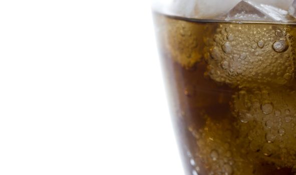 cola soft drink in a glass full of ice cubes
