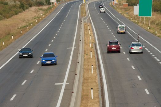 Highway with some cars passing by