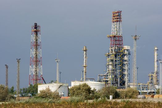 Industrial complex of an oil refinery with pipes and towers