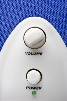 detail of a blue bass speaker with power and volume controls