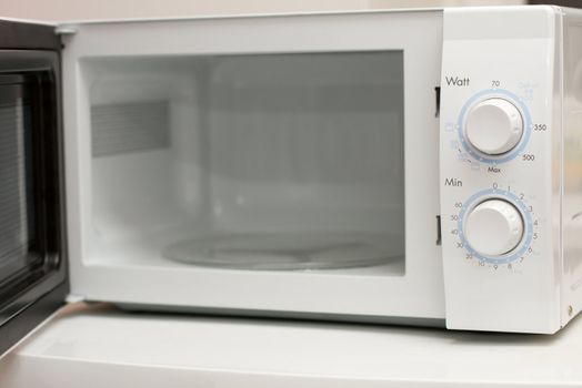 Open, white microwave oven