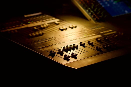 Soundboard mixer for concert PA in the dark, shallow DoF