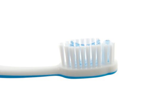 Closeup detail of a toothbrush on white background