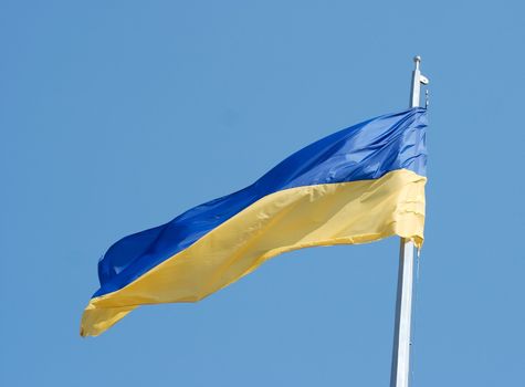 Ukranian national flag against clear blue sky