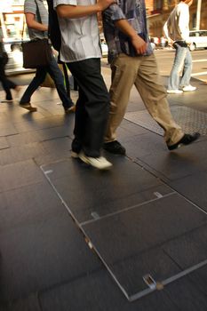 detail photo of several pedestrian feet, motion blur