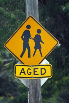 yellow sign 'aged' with a man and woman figure, australian street sign
