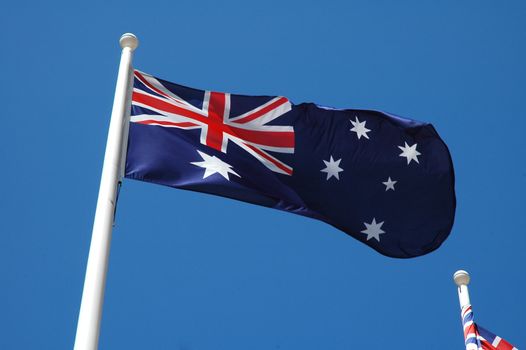 australian flag waving, blue sky without clouds,