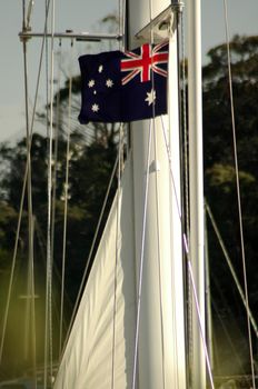 australian flag waving on a yacht mast