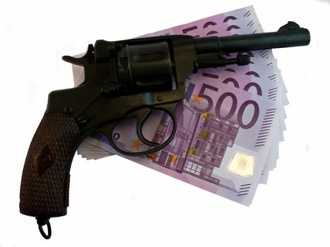 A gun lying on top of pile of money