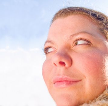 Young woman looking at blue copy space