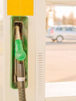 Service Station - Fuel nozzle with car in background