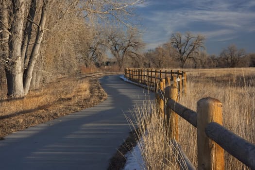 rural windy bike trail in Colorado from Windsor to Greeley along Poudre River,  typical winter conditions with just traces of snow