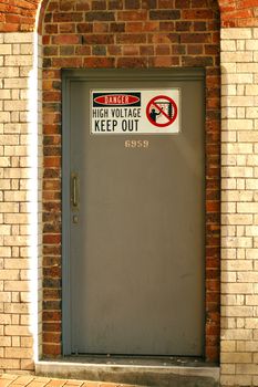 door to switch room, keep out sign, brick wall