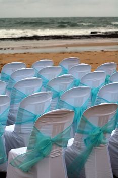 detail photo of chairs on a beach prepared for wedding