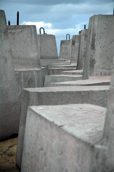 several heavy grey cement blocks, blue sky