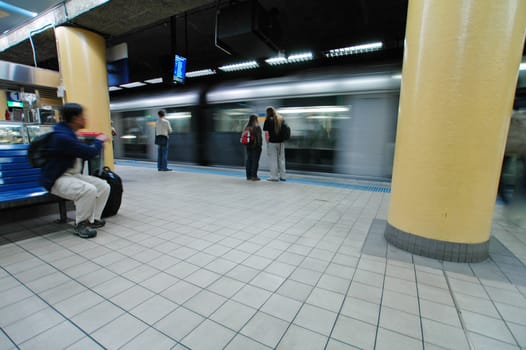 sydney metro station, blured train, passangers waiting,wide angle shot