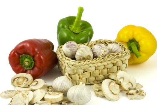 Bell peppers with fresh garlics and sliced champignon mushrooms isolated on white background.